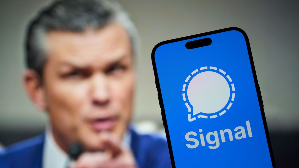 The Signal encrypted messaging application is seen on a mobile device with an image of Pete Hegseth in the background in this illustration photo taken in Warsaw, Poland on 25 March, 2025. (Photo by Jaap Arriens/NurPhoto via Getty Images)