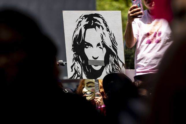 epa09297668 A demonstrator holds a poster showing a portrait of Britney Spears with tape on her mouth as hundreds demonstrators rally during a #FREEBRITNEY protest in front of the court house where Britney Spears addresses the court in conservatorship hearing in Los Angeles, California, USA, 23 June 2021.  EPA/ETIENNE LAURENT Dostawca: PAP/EPA.