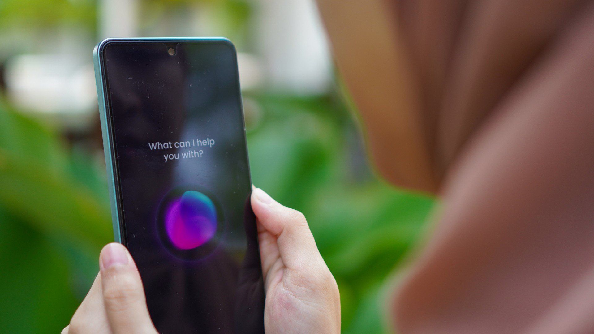 Muslim Woman using voice assistant on smartphone