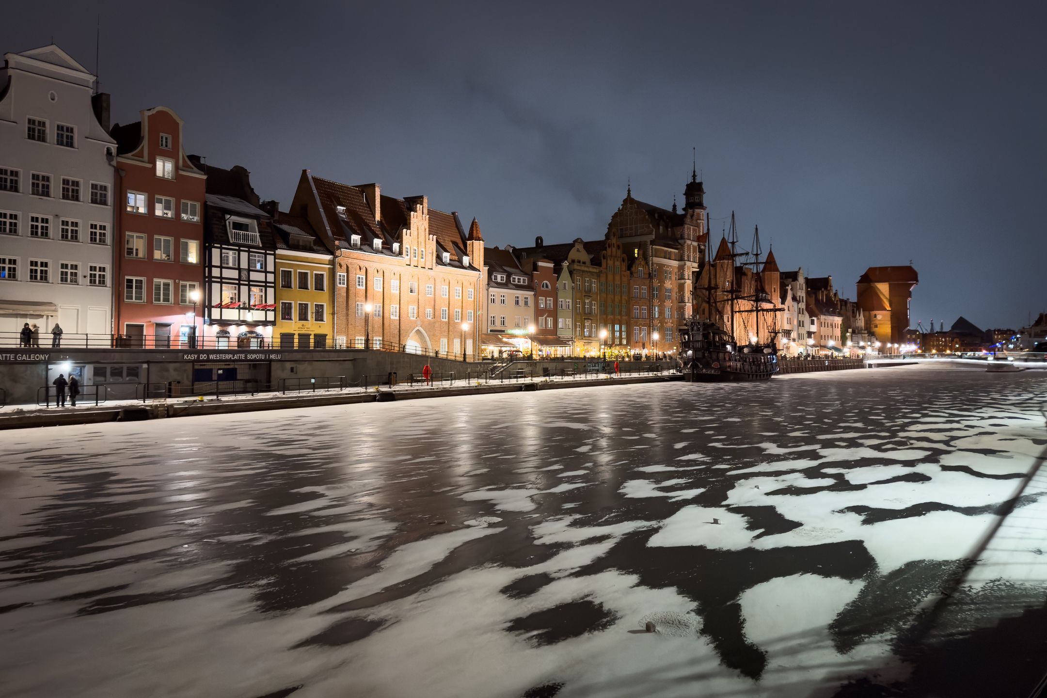 The Long Embankment stretches along the Old Motlawa River, with historic buildings and the Bread Gate visible at night, viewed from Granary Island in Gdansk, Poland, on January 10, 2026. (Photo by Mateusz Wlodarczyk/NurPhoto via Getty Images)