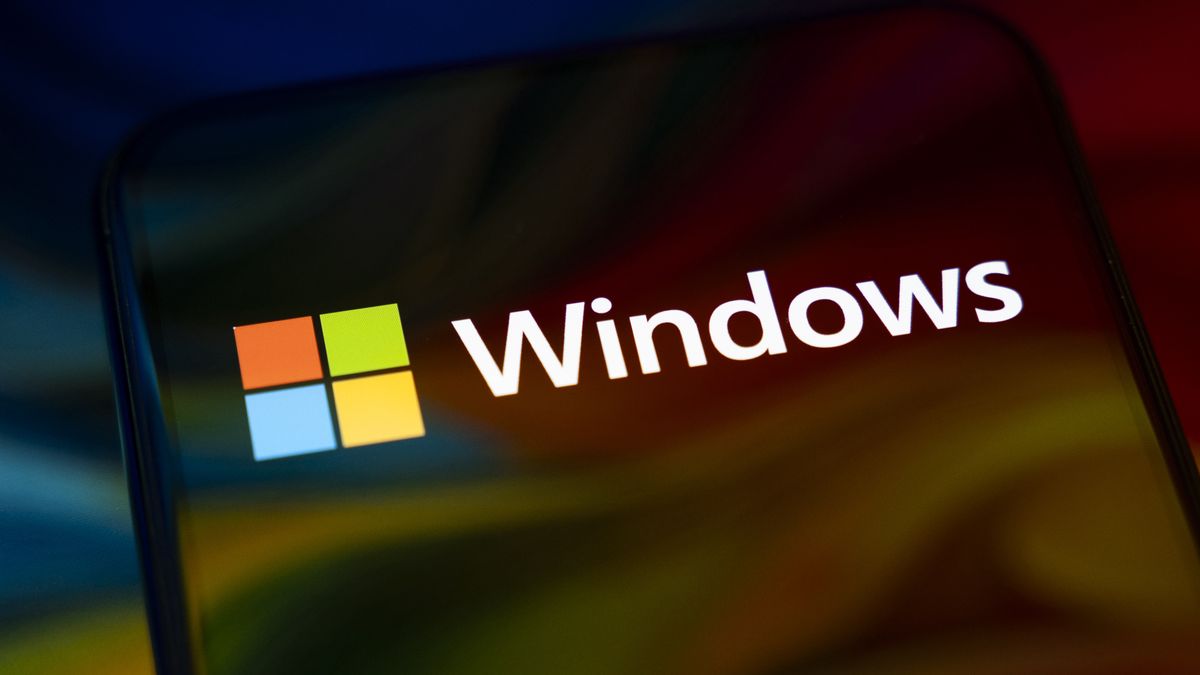 The Windows logo appears on the screen of a smartphone, which reflects an abstract illustration in Microsoft's colors of red, green, blue, and yellow. Microsoft releases a major update to Windows 11 (25H2), and support for Windows 10 ends definitively on October 14. In Creteil, France, on October 9, 2025. (Photo by Samuel Boivin/NurPhoto via Getty Images)
