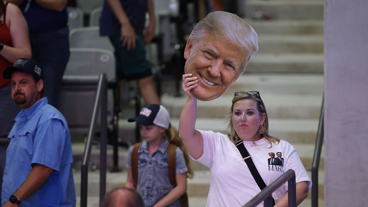 MACON, GEORGIA - NOVEMBER 03: A supporter holds 
a cutout photograph of Republican presidential nominee, former President Donald Trump during a campaign rally at the Atrium Health Amphitheater on November 03, 2024 in Macon, Georgia. With only two days until the election, Trump is campaigning for re-election on Sunday in the battleground states of Pennsylvania, North Carolina and Georgia. (Photo by Chip Somodevilla/Getty Images)