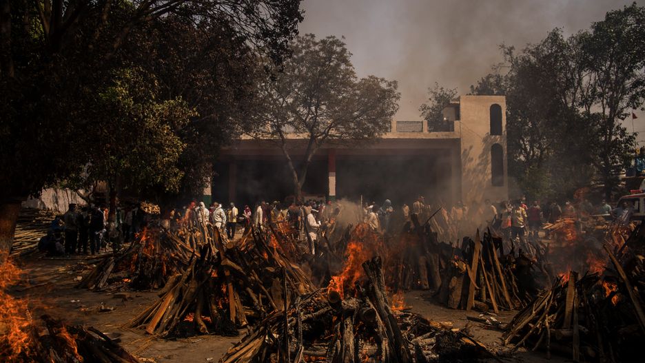 (EDITORS NOTE: Image depicts death.) Funeral pyres burn at a crematorium in New Delhi, India, on Friday, April 23, 2021. Bodies piling up at crematoriums and burial grounds across India are sparking concerns that the death toll from a ferocious new Covid-19 wave may be much higher than official records, underplaying the scale of a resurgence that is overwhelming the country's medical system. Photographer: Anindito Mukherjee/Bloomberg via Getty Images