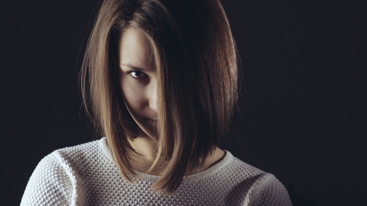 Woman hair covered face portrait in studio on dark backgroundWoman hair covered face portrait in studio on dark backgrounddisqisdangerous, psycho, psychopath, senior, up