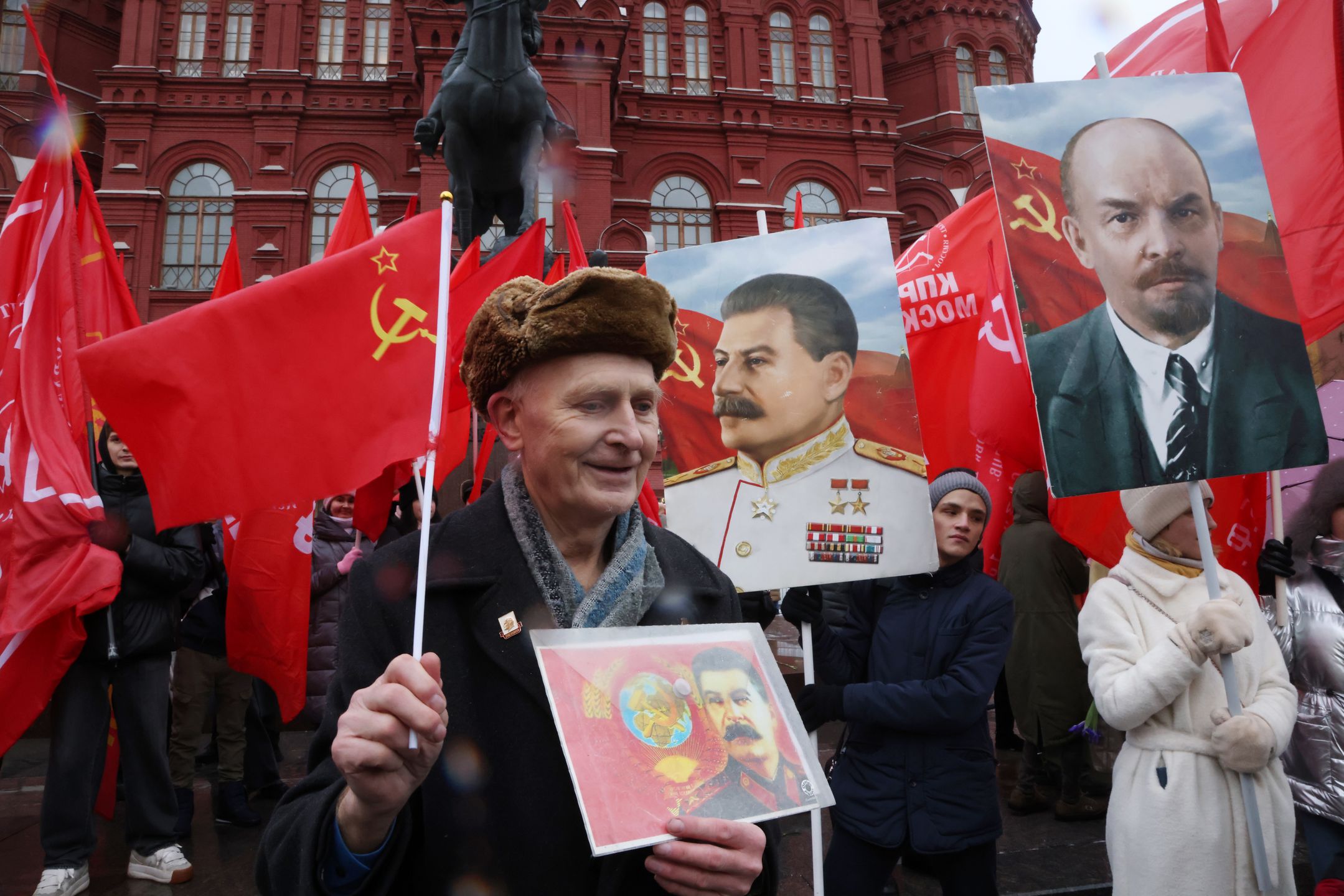MOSCOW, RUSSIA - DECEMBER 21: (RUSSIA OUT) Supporters of Russian Communist Party CPRF hold Soviet flags and portrait of Soviet leader Joseph Staling during their rally on December 21, 2023, in Moscow, Russia. Hundreds of communists participated in the rally at Moscow's Red Square, marking the 144th anniversary of Soviet leader Joseph Stalin. (Photo by Contributor/Getty Images)