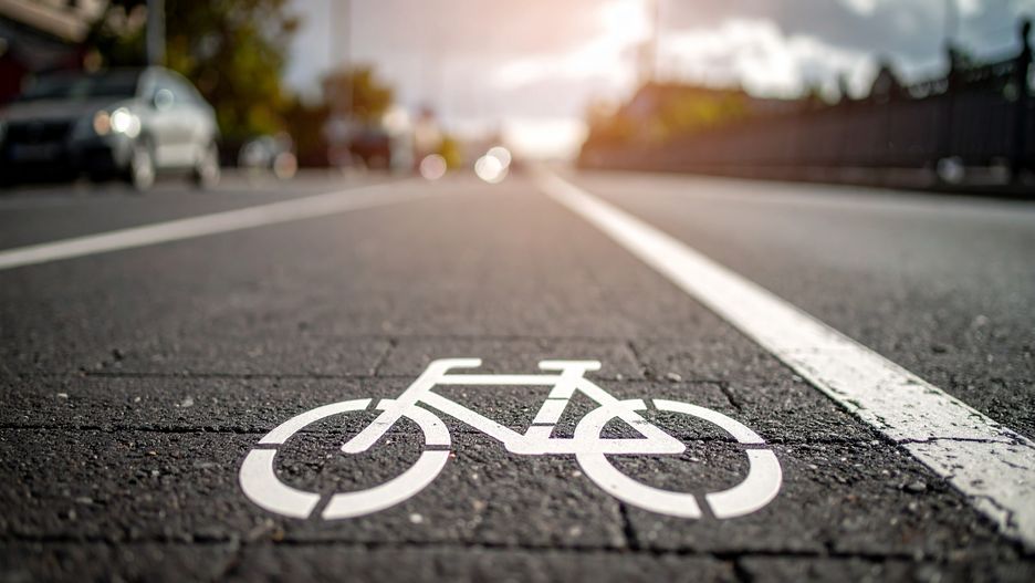 bicycle lane, bike path, cycling, urban cycling, city street, sustainable transportation, road marking, pavement, bicycle symbol, bike, city, urban, transport, infrastructure, street, road, transportation, traffic, way, lane, cycle, path, cycling infrastructure, urban design, sustainable, eco-friendly, environment, travel, commute, journey, freedom, healthy lifestyle, active lifestyle, wellbeing, fitness, asphalt, lines, marking, signage, public space, urban planning, safety, security, wayfinding, navigation, direction, guidance, cyclist, commuter