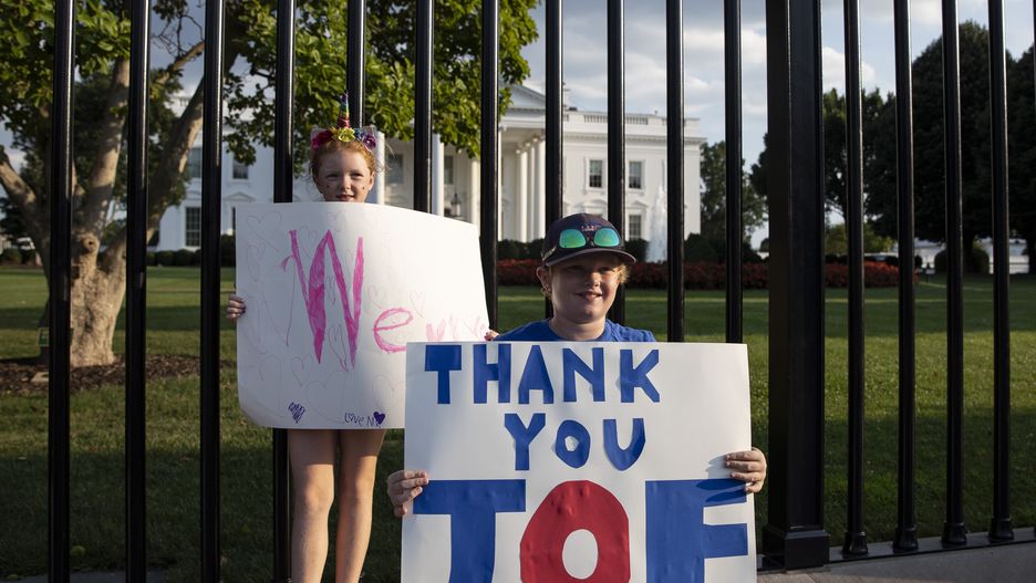 WASHINGTON DC, UNITED STATES - JULY 21: People hold banners outside the White House after U.S. President Joe Biden announced he is dropping out of the US election in Washington DC, United States on July 21, 2024. (Photo by Mostafa Bassim/Anadolu via Getty Images)