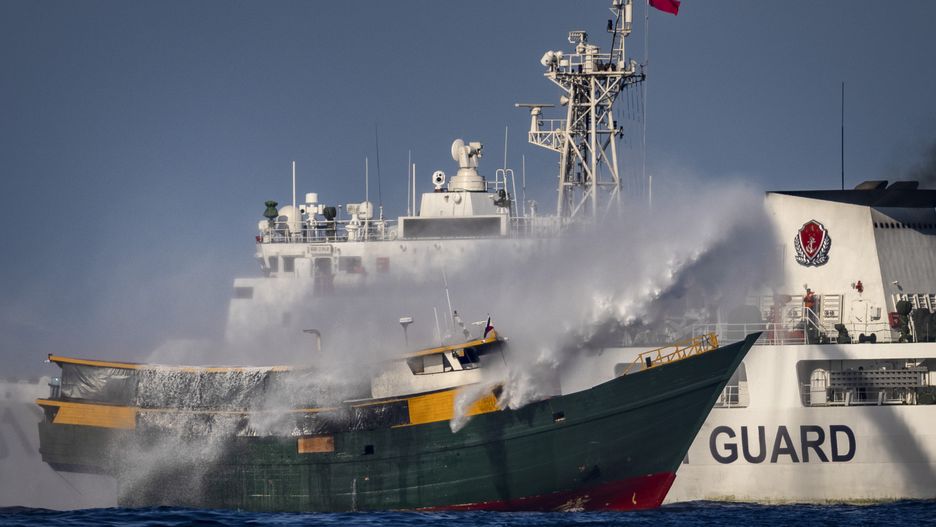 SOUTH CHINA SEA - MARCH 05: A Chinese Coast Guard ship fires a water cannon at Unaizah May 4, a Philippine Navy chartered vessel, conducting a routine resupply mission to troops stationed at Second Thomas Shoal, on March 05, 2024 in the South China Sea. Philippine and Chinese vessels collided in the high seas, leaving four Filipinos with minor injuries after a supply vessel's windshield was shattered by water cannons, the Philippines said. The incidents happened as the Philippines was conducting a routine resupply mission to troops stationed aboard BRP Sierra Madre, a grounded Navy ship that serves as the country's outpost in Second Thomas Shoal (locally called Ayungin Shoal). (Photo by Ezra Acayan/Getty Images)