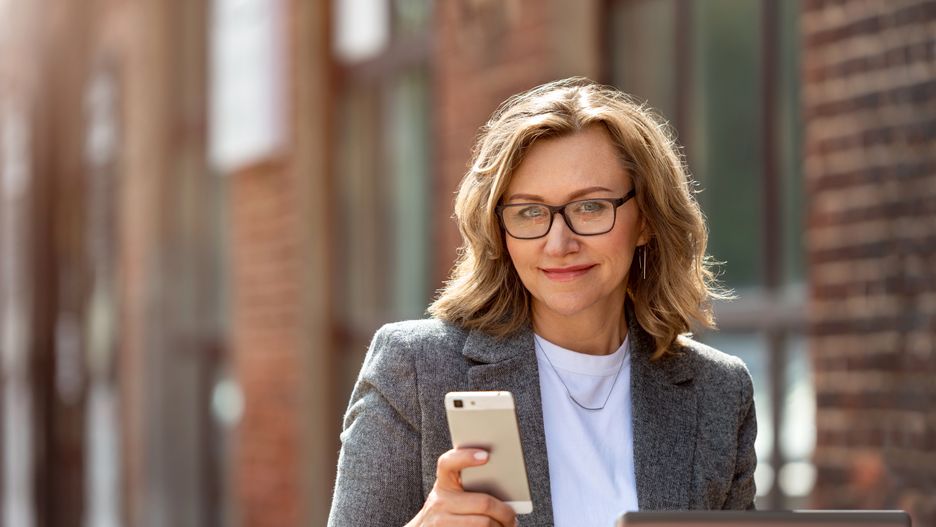 woman, business, phone, mobile, businesswoman, middle, age, people, beautiful, smartphone, computer, laptop, happy, 55 years old, communication, person, technology, mature, smiling, portrait, 50-59, 55-59, holding, cellphone, telephone, smile, cell, using, outdoors, outdoor, pretty, caucasian, blond, blonde, hair, modern, glasses
