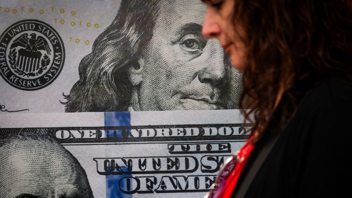BUENOS AIRES, ARGENTINA - DECEMBER 04: A woman walks by a currency exchange house on December 04, 2023 in Buenos Aires, Argentina. President-elect Javier Milei of La Libertad Avanza will take office on Sunday 10, replacing incumbent peronist Alberto Fernandez. Milei is a self-described "anarcho-capitalist" libertarian who wants to sharply reduce the size of the State and replace the local peso with the American dollar. During the campaign, he promised to uproot Argentina's political establishment and to align the economy with dramatic measures such as closing the Central Bank. After defeating the current Minister of Economy Sergio Massa in the run-off with 55,65% of the votes, the president-elect has shown moderation and pragmatism as he works on the line up of his cabinet. The new administration will face the challenge to reduce the country's 140% annual inflation and its 44,7% of poverty, as recently announced by a study carried out by ODSA-UCA.  (Photo by Tomas Cuesta/Getty Images)