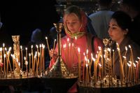 KYIV, UKRAINE - MAY 5, 2024 - Women place burning candles at St Michael's Golden-Domed Cathedral on Orthodox Easter, Kyiv.  (Photo credit should read Eugen Kotenko / Ukrinform/Future Publishing via Getty Images)
