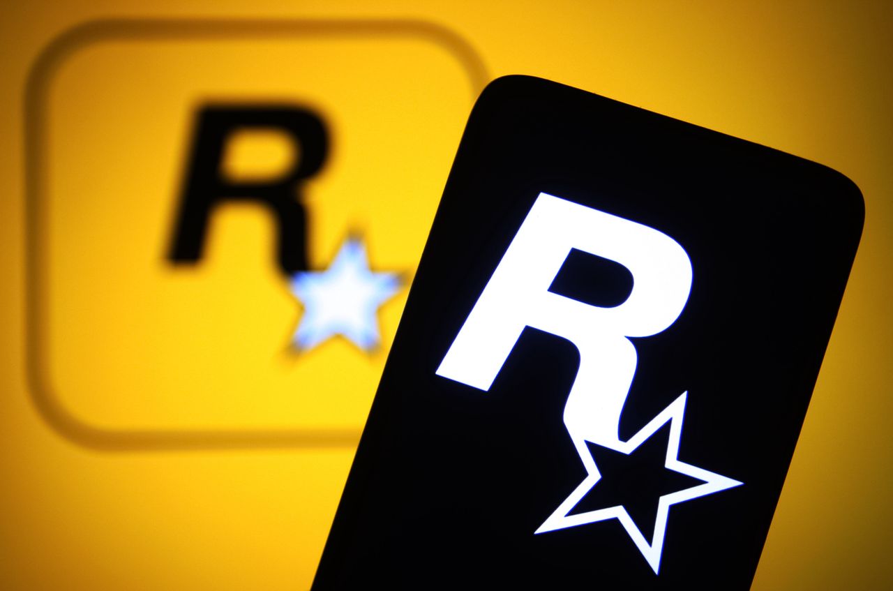 UKRAINE - 2022/02/11: In this photo illustration, a Rockstar Games Inc logo of a video game publisher is seen on a smartphone and a computer screen. (Photo Illustration by Pavlo Gonchar/SOPA Images/LightRocket via Getty Images)