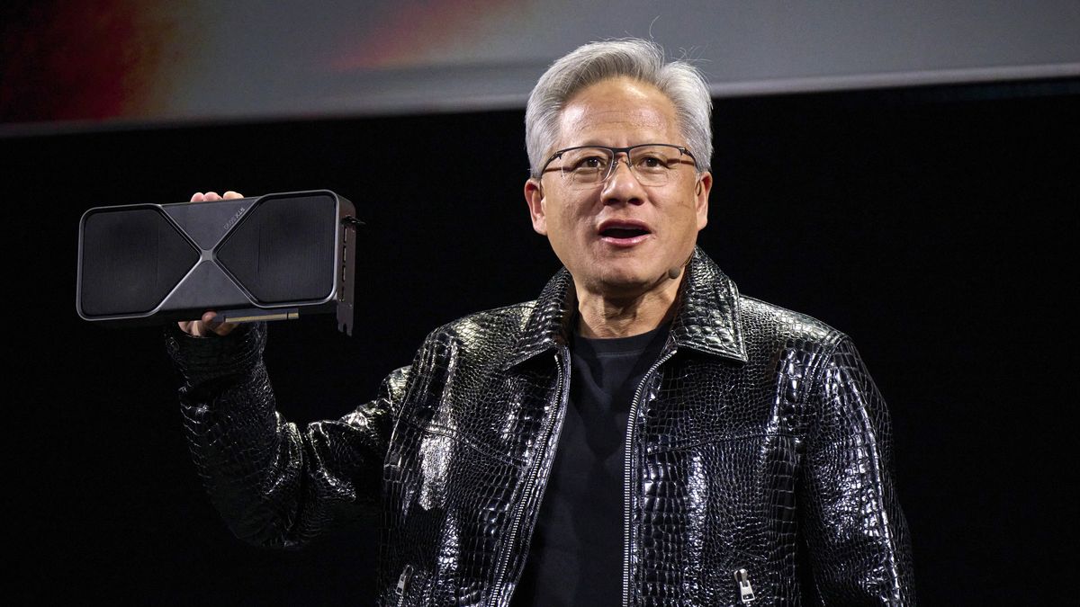 Jensen Huang, co-founder and chief executive officer of Nvidia Corp., speaks while holding the company's new GeForce RTX 5090 model graphics card during the 2025 CES event in Las Vegas, Nevada, US, on Monday, Jan. 6, 2025. Huang announced a raft of new chips, software and services, aiming to stay at the forefront of artificial intelligence computing. Photographer: Bridget Bennett/Bloomberg via Getty Images