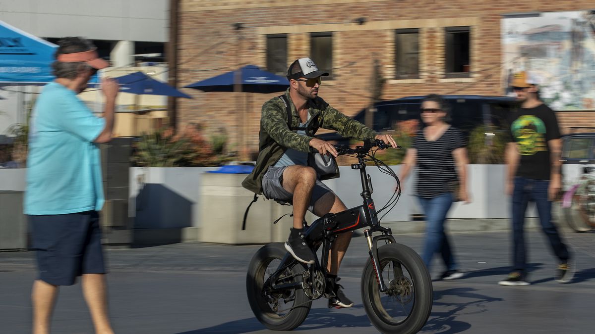 HERMOSA BEACH, CA-NOVEMBER 10, 2023, 2023:A man rides his e-bike on the Strand in Hermosa Beach. In Hermosa Beach, it's against city code to use electric power on the Strand, but many e-bike riders do so anyway.  (Mel Melcon / Los Angeles Times via Getty Images)