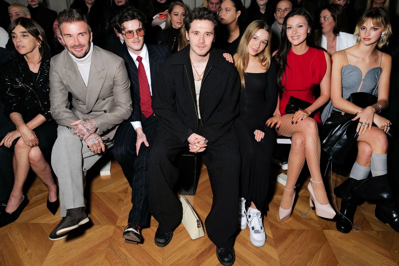 PARIS, FRANCE - MARCH 01: (L-R) Carine Roitfeld, David Beckham, Cruz Beckham Brooklyn Peltz Beckham, Harper Beckham, Nicola Peltz Beckham and Mia Regan attend the Victoria Beckham AW24 show during Paris Fashion Week on March 01, 2024 in Paris, France. (Photo by Darren Gerrish/WireImage for Victoria Beckham)