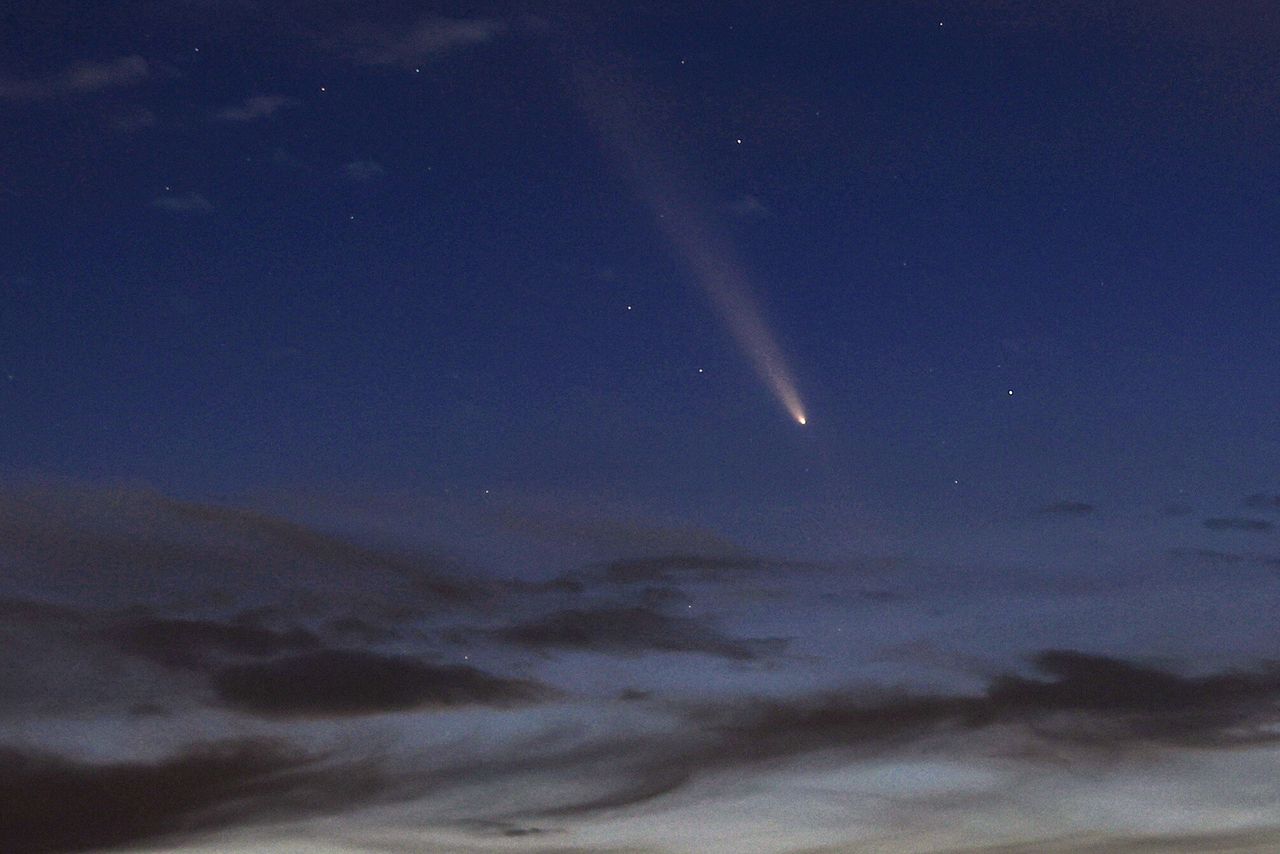 Starlink satellites and comet tail meet in rare sky event