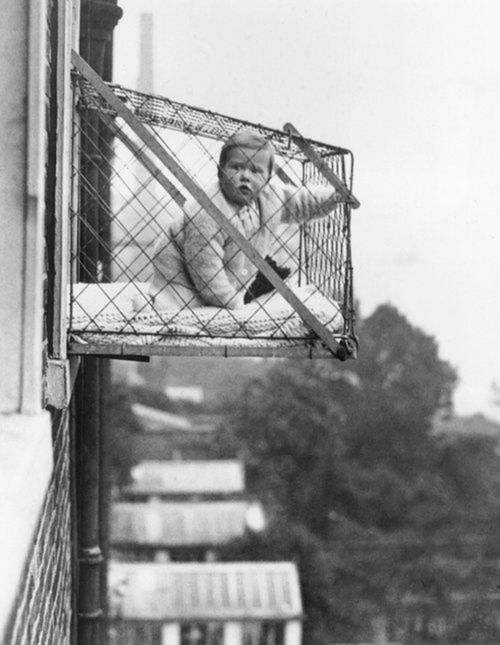 27th January 1934:  An example of the wire cage which East Poplar borough council in London propose to fix to the outside of their tenement windows, so that babies can benefit from fresh air and sunshine.  (Photo by Fox Photos/Getty Images)