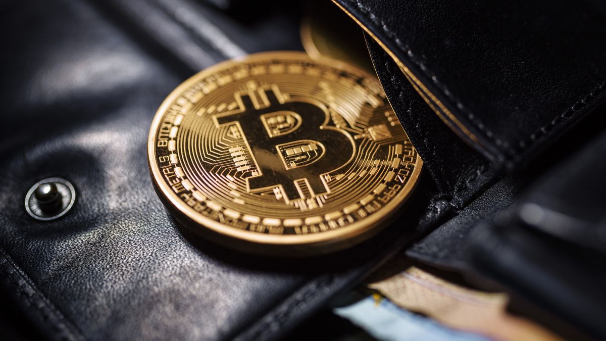 BERLIN, GERMANY - AUGUST 15: Symbolic photo on the topic of Bitcoin. A Coin with the Bitcoin logo lying in a wallet on August 15, 2025 in Berlin, Germany. (Photo Illustration by Thomas Trutschel/Photothek via Getty Images)