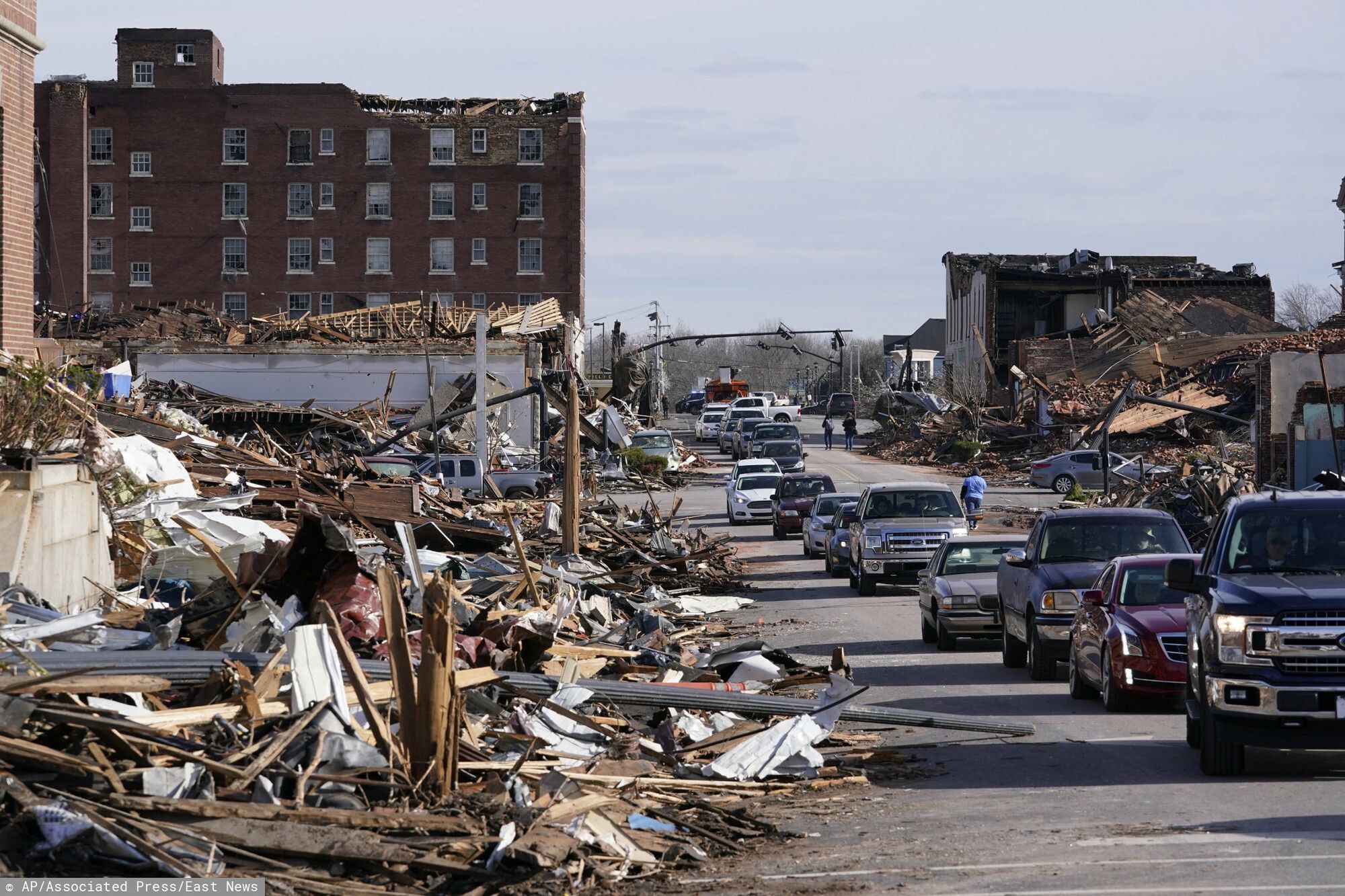 TemporaryPeople survey damage from a tornado is seen in Mayfield, Ky., on Saturday, Dec. 11, 2021. Tornadoes and severe weather caused catastrophic damage across multiple states late Friday, killing several people overnight. (AP Photo/STFAP