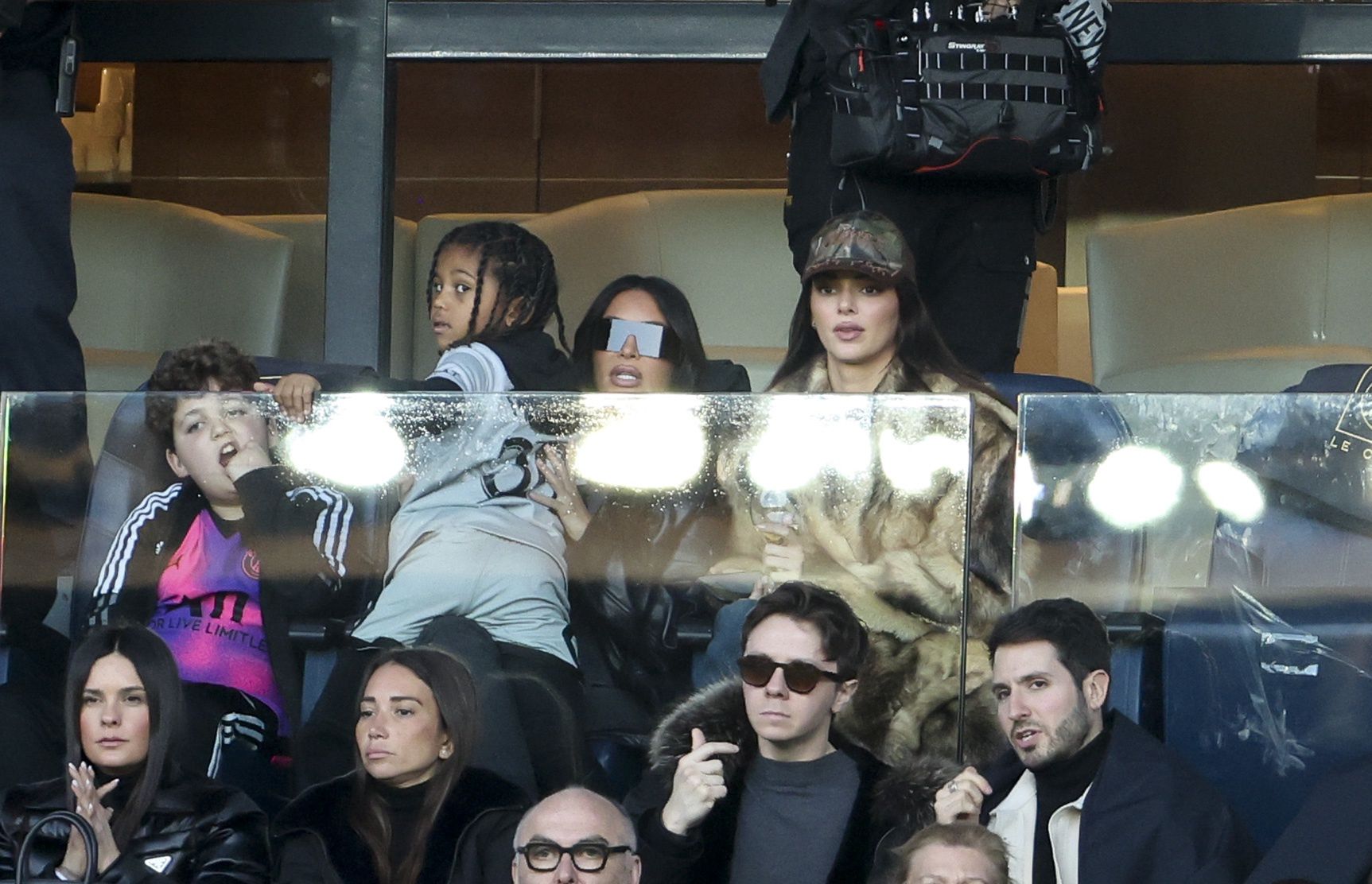 PARIS, FRANCE - MARCH 19: Kim Kardashian holding her son Saint West, Kendall Jenner attend the Ligue 1 Uber Eats match between Paris Saint-Germain (PSG) and Stade Rennais (Rennes) at Parc des Princes stadium on March 19, 2023 in Paris, France. (Photo by Jean Catuffe/Getty Images)