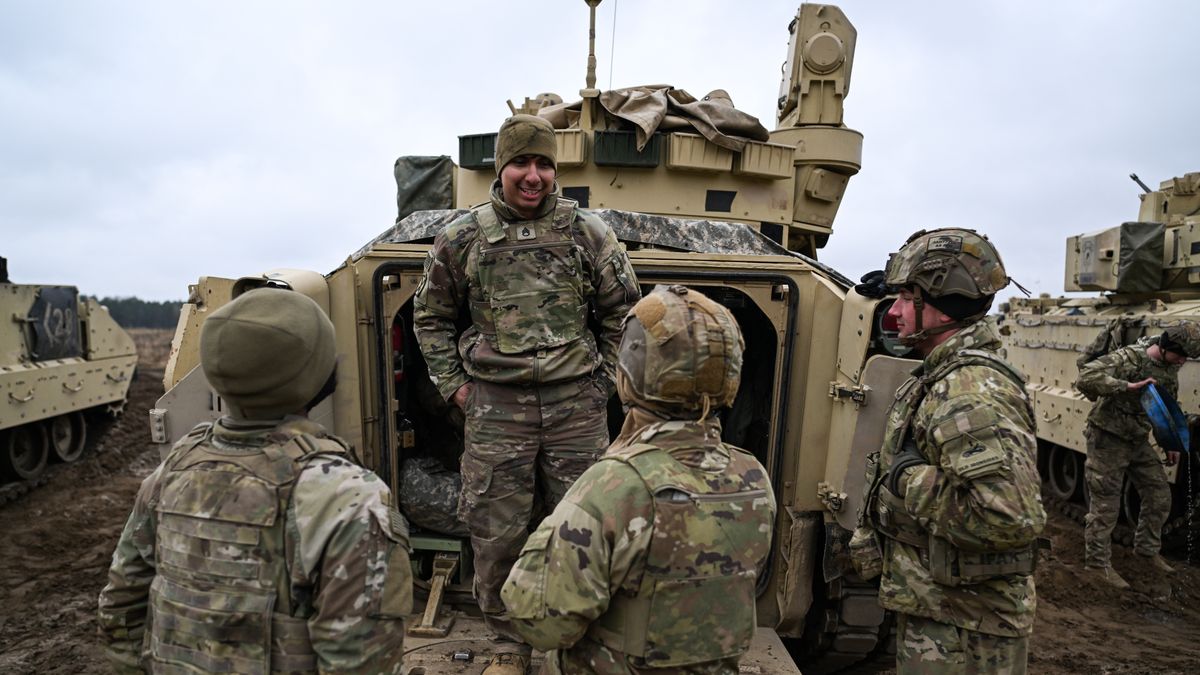 DRAWSKO POMORSKIE, POLAND - MARCH 13: Soldiers of the US Army 3rd Brigade, 1st Armored Division speak next to a Bradley Fighting Vehicle ahead of a live fire exercise at the Drawsko Pomorskie training area on March 13, 2025 in Drawsko Pomorskie, Poland. Poland has historically been one of America's closest European allies, currently hosting approximately 10,000 members of the US Armed Forces, who play a significant role in reinforcing security along NATO's eastern flank. Recently, however, the United States' ongoing military presence in Europe has been cast into doubt, as US President Donald Trump pressures NATO member states to increase their defence spending, and to decrease their reliance on America for its military funding and resources. (Photo by Omar Marques/Getty Images)