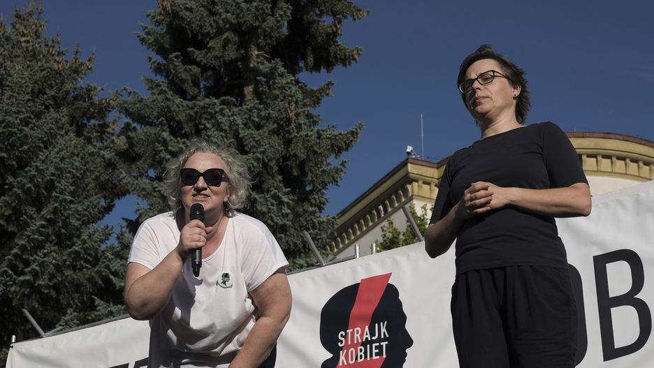 Marta Lempart, leader of All-Poland Women's Strike, left, speaks to protesters during a pro-abortion demonstration, by the All-Poland Women's Strike, outside the Polish parliament in Warsaw, Poland, on Tuesday, July 23, 2024. Polish Prime Minister Donald Tusk's government failed to pass legislation to decriminalize abortion in a tight vote, laying bare divisions within the ruling coalition on an issue that's polarized the nation. Photographer: Damian Lemanski/Bloomberg via Getty Images