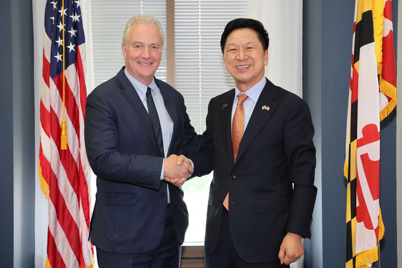 A handout photo made available by South Korea's ruling People Power Party shows head of party Kim Gi-hyeon (R) posing for a photo with chairman of the US senate foreign relations subcommittee on East Asia and the Pacific, Chris Van Hollen, during a meeting in Washington, DC, USA, 11 July 2023 (issued 12 July 2023).