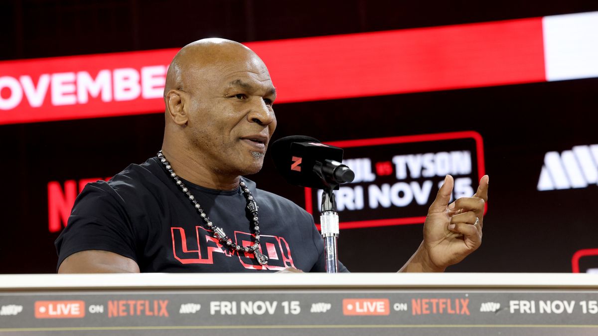 NEW YORK, NEW YORK - AUGUST 18: Mike Tyson and Jake Paul face off at an exclusive press conference ahead of their November bout during the Fanatics Fest NYC 2024 at Jacob Javits Center on August 18, 2024 in New York City.  (Photo by Kevin Mazur/Kevin Mazur/Getty Images for Fanatics)