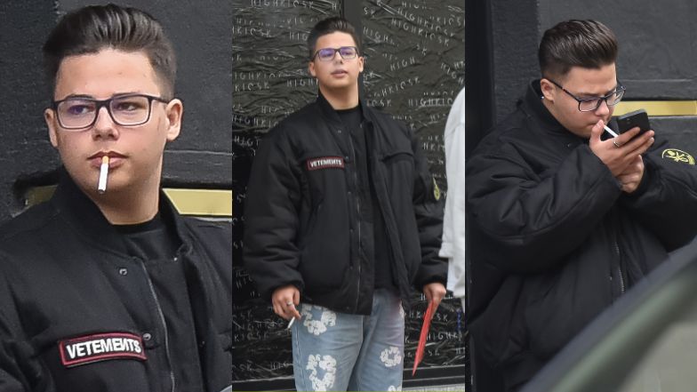 Allan Krupa pali papierosa przed butikiem