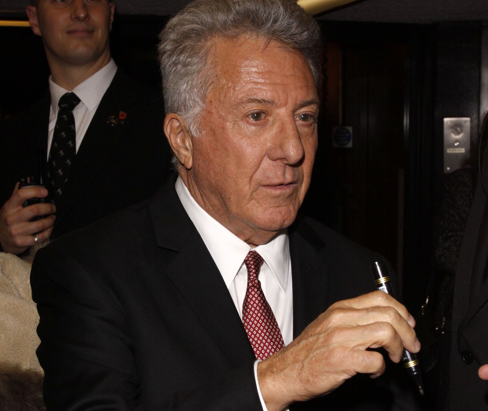Esio Trot - gala TV premiereLONDON, ENGLAND - NOVEMBER 12 :  Dustin Hoffman leaves the Esio Trot - gala TV premiere at the Curzon Mayfair on November 12, 2014 in London, England.CAP/AH©Adam Houghton/Capital PicturesCapital Pictures/allONSblack suit, half length, signing autographs