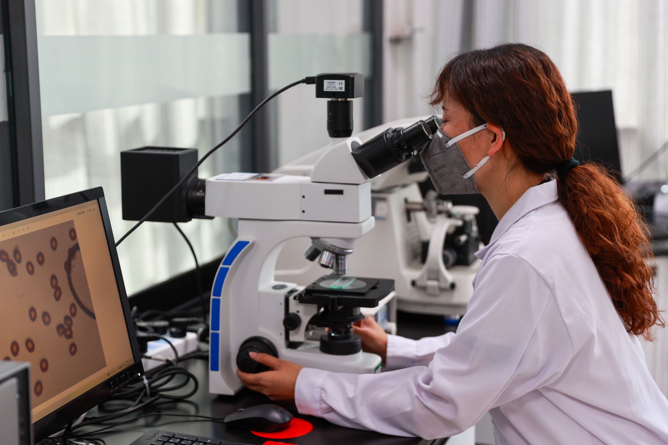 XINING, CHINA - MAY 22: A technician tests the properties of carbon fiber at Zhongfu Shenying Carbon Fiber Xining Co., Ltd. on May 22, 2025 in Xining, Qinghai Province of China. (Photo by Xue Di/China News Service/VCG via Getty Images)