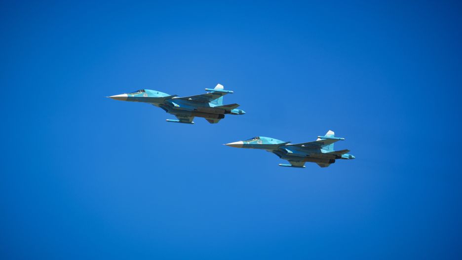 Two Russian Su-34 fighter-bombers flying on the clean sky.