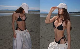 Sofi napina umięśniony brzuch, eksponując powiększone piersi w bikini na kanadyjskiej plaży
