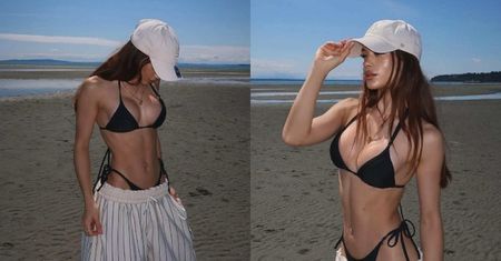 Sofi napina umięśniony brzuch, eksponując powiększone piersi w bikini na kanadyjskiej plaży