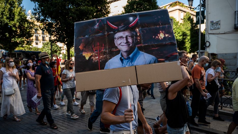 MADRID, SPAIN - 2020/09/05: A man carrying a picture of Bill Gates protesting during a demonstration against the mandatory use of face masks, the use of a vaccine against coronavirus, the implementation of 5G, and other measures adopted by the Spanish government to prevent the spread of coronavirus in Spain as COVID-19 positive cases continue to increase. (Photo by Marcos del Mazo/LightRocket via Getty Images)