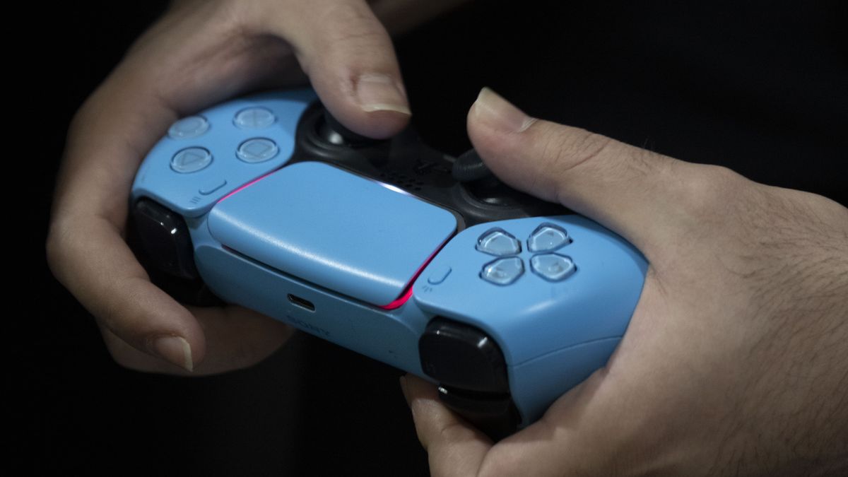 An Iranian gamer uses a PS5 controller to participate in a video game competition during the 11th Iran Video Games Festival at the Tehran Milad Tower Cultural and Recreational Complex in Tehran, Iran, on February 18, 2026. (Photo by Morteza Nikoubazl/NurPhoto via Getty Images)