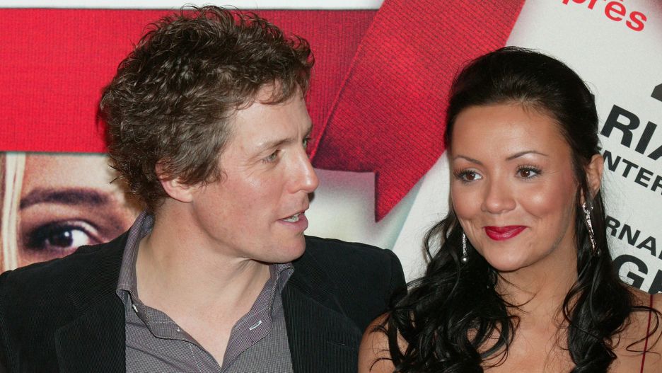 Hugh Grant  Martine McCutcheon. (Photo by Stephane Cardinale/Corbis via Getty Images)Stephane Cardinale - Corbistwo people:CB1, smiling:CB2, half-length:CB1, portrait:CB2, suits:CB2, dress:CB2, celebrities:CB2, movie:CB2, Paris:CB2