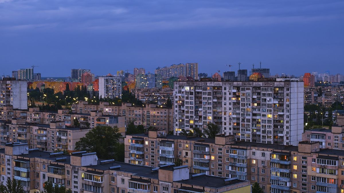 Twilight cityscape at sleeping residential district of Kyiv city. Soviet architecture style of Former USSR
Yellow-colored  illuminated windows in contrast of blue sky tones. Residential district of Kyiv city "Rusanivka". Panel buildings made in Former USSR, used to build of pre-made concrete blocks. Old, soviet style dormitory buildings. Summer time at night.  Multicolor nightscape  of  Kyiv neighborhood
Artem Hvozdkov