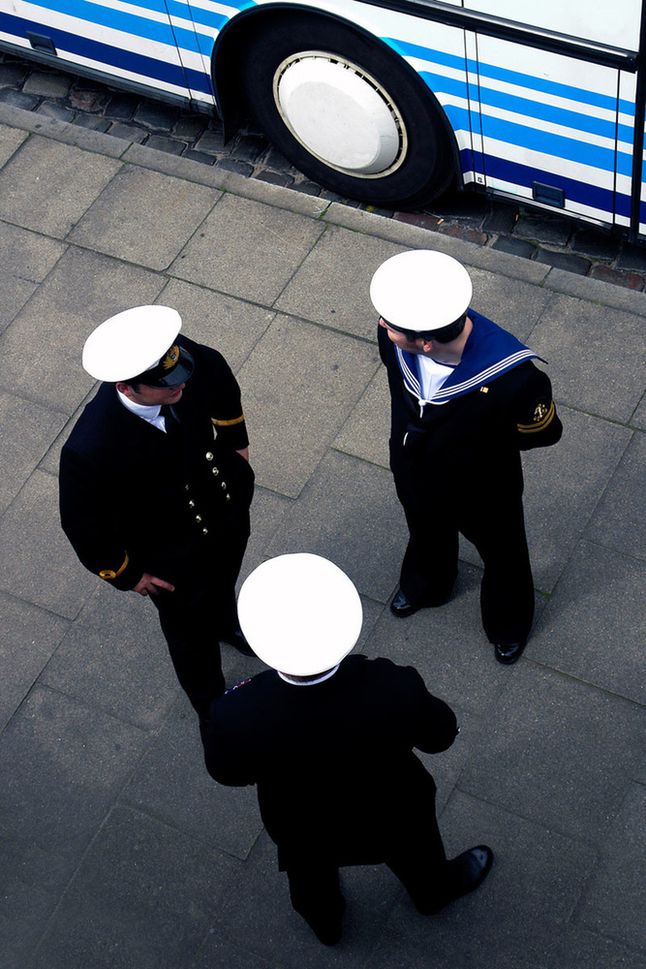 Zdjęcie Hansena przedstawia trzech marynarzy rozmawiających przed autobusem. Niby wydaje się to być zwykłą chwilą, lecz zwróćcie uwagę na zależność kolorystyczną między chustą marynarza po prawej stronie oraz malowaniem autobusu. koło wydaje się być "czwartym marynarzem".
