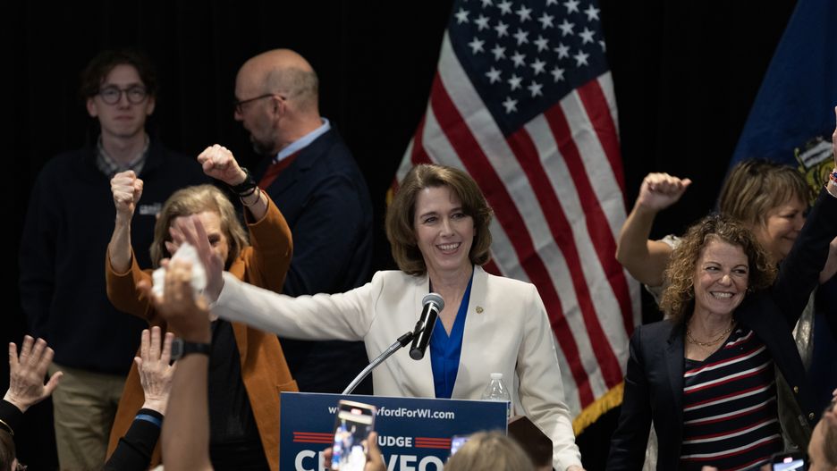 MADISON, WISCONSIN - APRIL 01: Dane County Circuit Court Judge Susan Crawford (C) reacts with supporters after her victory in the race for Wisconsin Supreme Court justice during an election night event on April 01, 2025 in Madison, Wisconsin. The former prosecutor ran against Judge Brad Schimel, who was endorsed by President Donald Trump and financially supported by billionaire businessman Elon Musk. (Photo by Scott Olson/Getty Images)