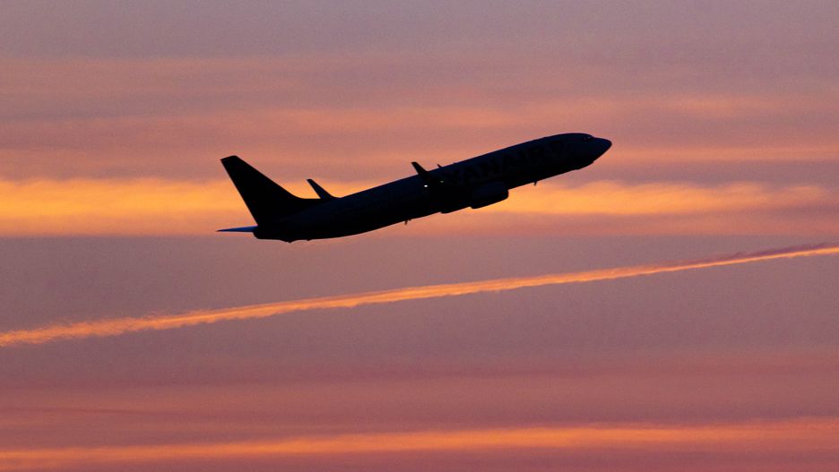 Aircraft silhouette, a symbol illustration photo during the magic hour of a departing passenger plane. Dusk and sunset golden hour with a colorful sky in Eindhoven. Images of a dark shape Boeing 737 airplane flying in the colorful European skyscape after take off. The airplane is a Boeing 737-800 of Ryanair low cost airline. During the summer of 2022 the European Aviation industry is facing long delays, cancellations and travel chaos mostly because of staff shortages at the airports after the Covid-19 Coronavirus pandemic era, air travel had increased demand. Eindhoven, the Netherlands on August 8, 2022 (Photo by Nicolas Economou/NurPhoto via Getty Images)