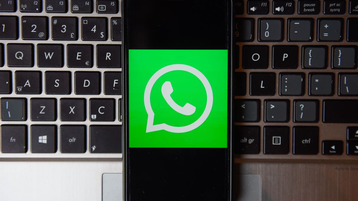 POLAND - 2020/10/21: In this photo illustration a WhatsApp logo seen displayed on a smartphone with a laptop keyboard on the background. (Photo Illustration by Omar Marques/SOPA Images/LightRocket via Getty Images)