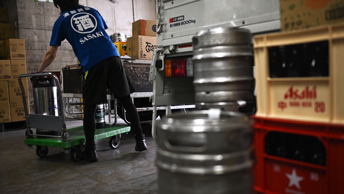 A worker helps load beer kegs onto a delivery truck at the Sasaki liquor store in Tokyo, Japan, on Friday, Oct. 3, 2025. Some retailers in Japan are warning customers of possible Asahi Super Dry beer shortages after a cyberattack paralyzed production and distribution at Asahi Group Holdings Ltd. Photographer: Soichiro Koriyama/Bloomberg via Getty Images