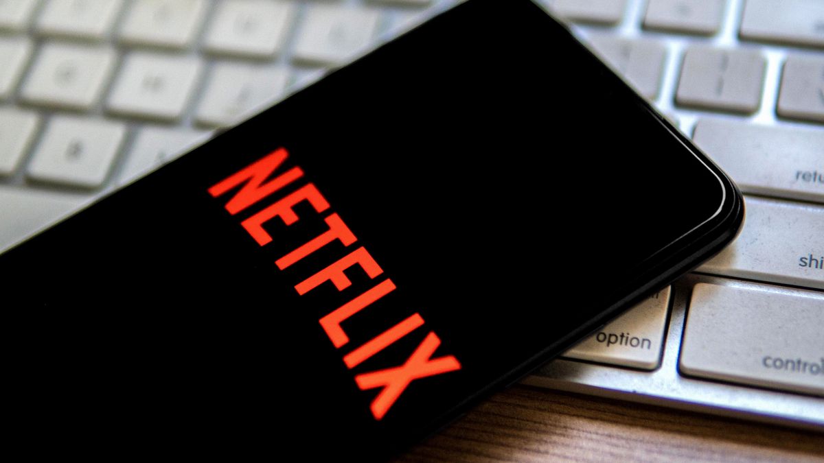 SPAIN - 2022/04/25: In this photo illustration, a Netflix logo seen displayed on a smartphone placed on top of a computer keyboard. (Photo Illustration by Thiago Prudencio/SOPA Images/LightRocket via Getty Images)
