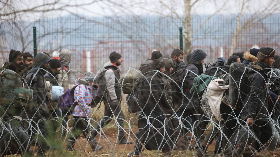 GRODNO REGION, BELARUS - NOVEMBER 15, 2021: Migrants by the Bruzgi - Kuznica checkpoint on the Belarusian-Polish border. The migrant crisis on the border of Belarus with Poland, Lithuania, and Latvia escalated on November 8. Several thousand migrants approached the Belarusian-Polish border and set up a tent camp there; some of them tried to cross the border by breaking a barbed wire fence. Leonid Shcheglov/BelTA/TASS (Photo by Leonid Shcheglov\TASS via Getty Images)
