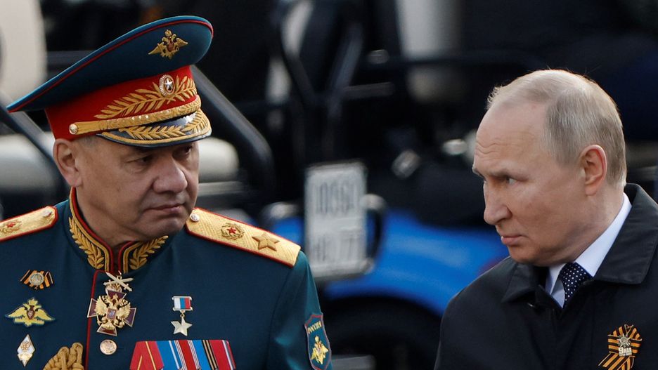 Russian President Vladimir Putin and Defence Minister Sergei Shoigu speak after a military parade on Victory Day, which marks the 77th anniversary of the victory over Nazi Germany in World War Two, in Red Square in central Moscow, Russia May 9, 2022.