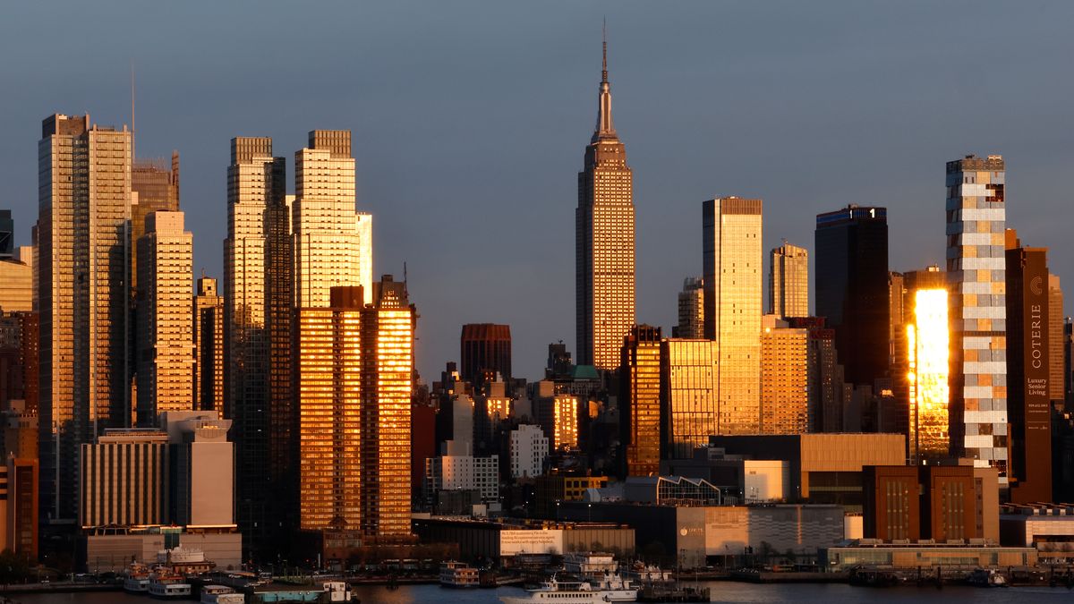 WEEHAWKEN, NJ - APRIL 20: The sun sets on the skyline of midtown Manhattan and the Empire State Building in New York City on April 20, 2025 in Weehawken, New Jersey.  (Photo by Gary Hershorn/Getty Images)