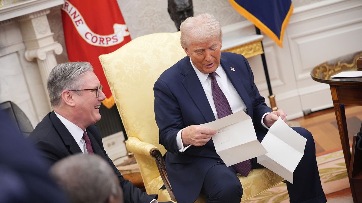 Donald Trump reads a letter from King Charles III given to him by British Prime Minister Keir Starmer 