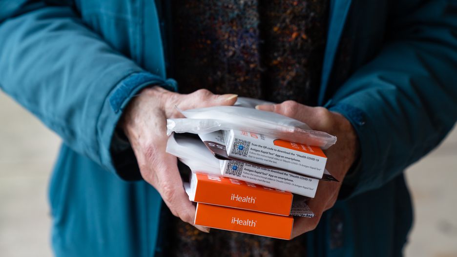 WASHINGTON, D.C. - MARCH 31: Helen schietinger, 74, holds her allotted masks and Covid-19 self-test kits outside the Peoples Congregational United Church of Christ, the site of the Ward 4 DC Covid Center, in Washington, D.C. on March 31, 2023. Friday is the last full day of DC's Covid Centers' operations. (Eric Lee for The Washington Post via Getty Images)