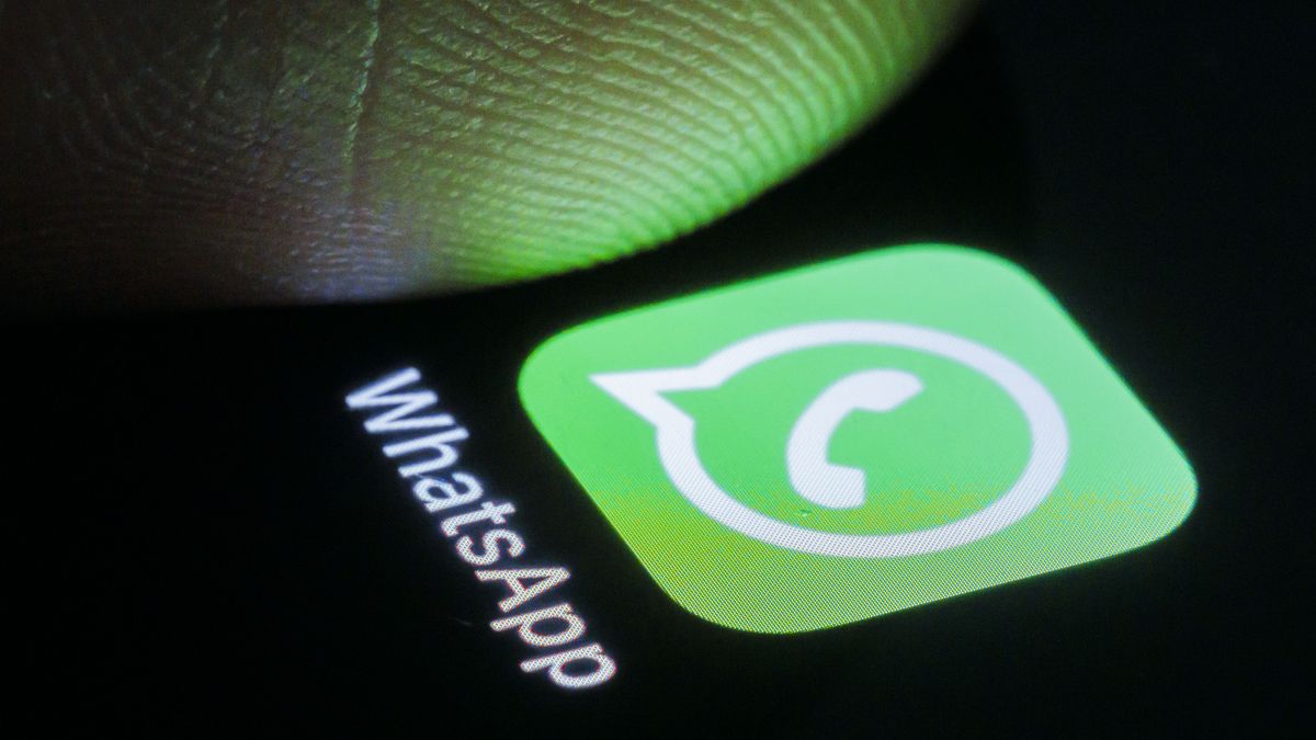 BERLIN, GERMANY - MARCH 27: In this photo illustration the messenger app WhatsApp can be seen on a smartphone next to a finger on March 27, 2024 in Berlin, Germany. (Photo Illustration by Thomas Trutschel/Photothek via Getty Images)